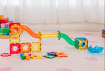 Rainbow coloured ball run in light filled playroom