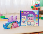 Colorful magnetic building tiles and their packaging on a table.