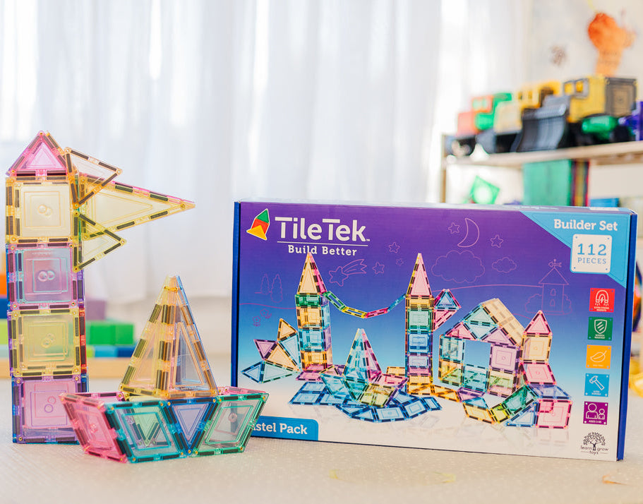 Colourful magnetic building tiles and their packaging on a table.