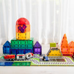 Dome train station made from magnetic tils with train tile toppers and trains set up on floor 